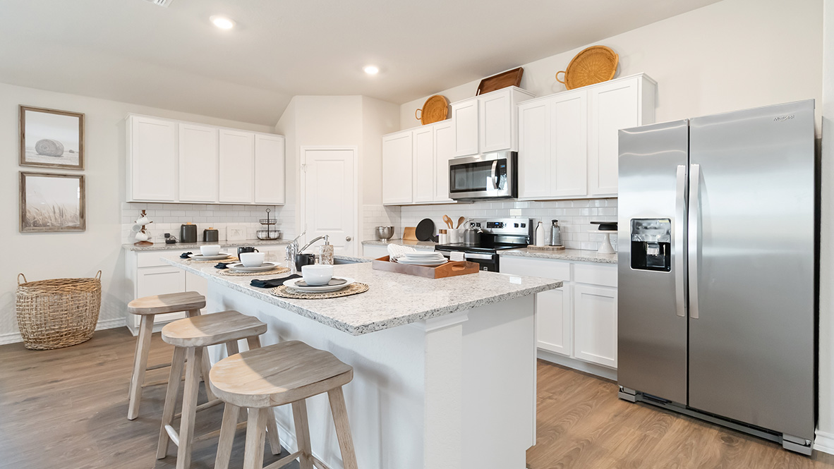 Open-concept kitchen with quartz or quartz countertops, subway tile backsplash, stainless steel appliances and corner pantry