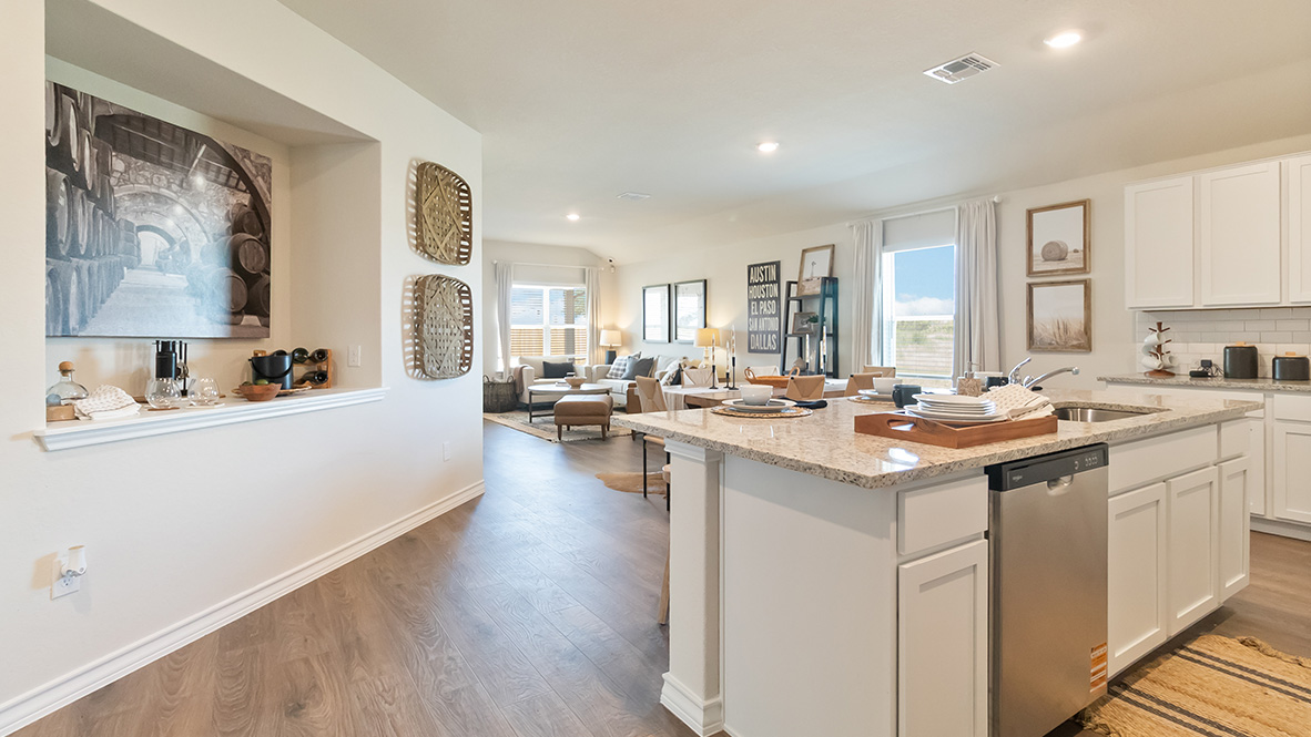 Open-concept kitchen with decorative nook facing the family room.