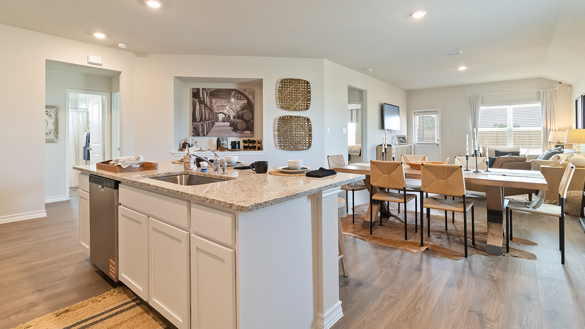 Open-concept kitchen with decorative nook facing the family room.