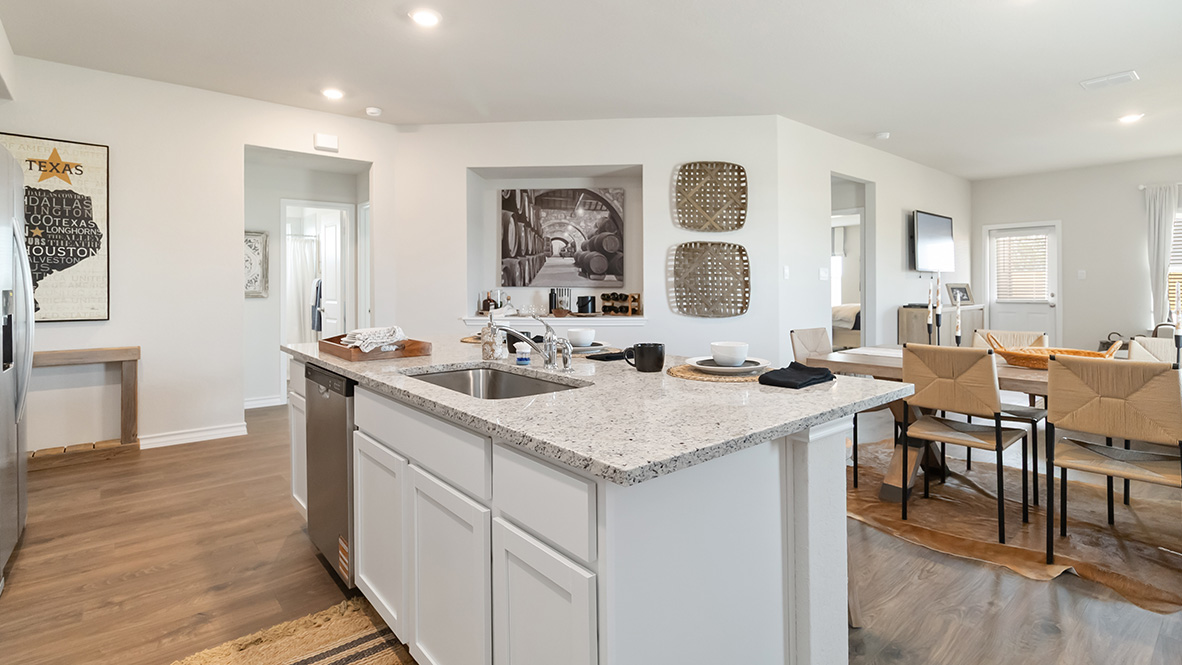 Open-concept kitchen with decorative nook facing the family room.