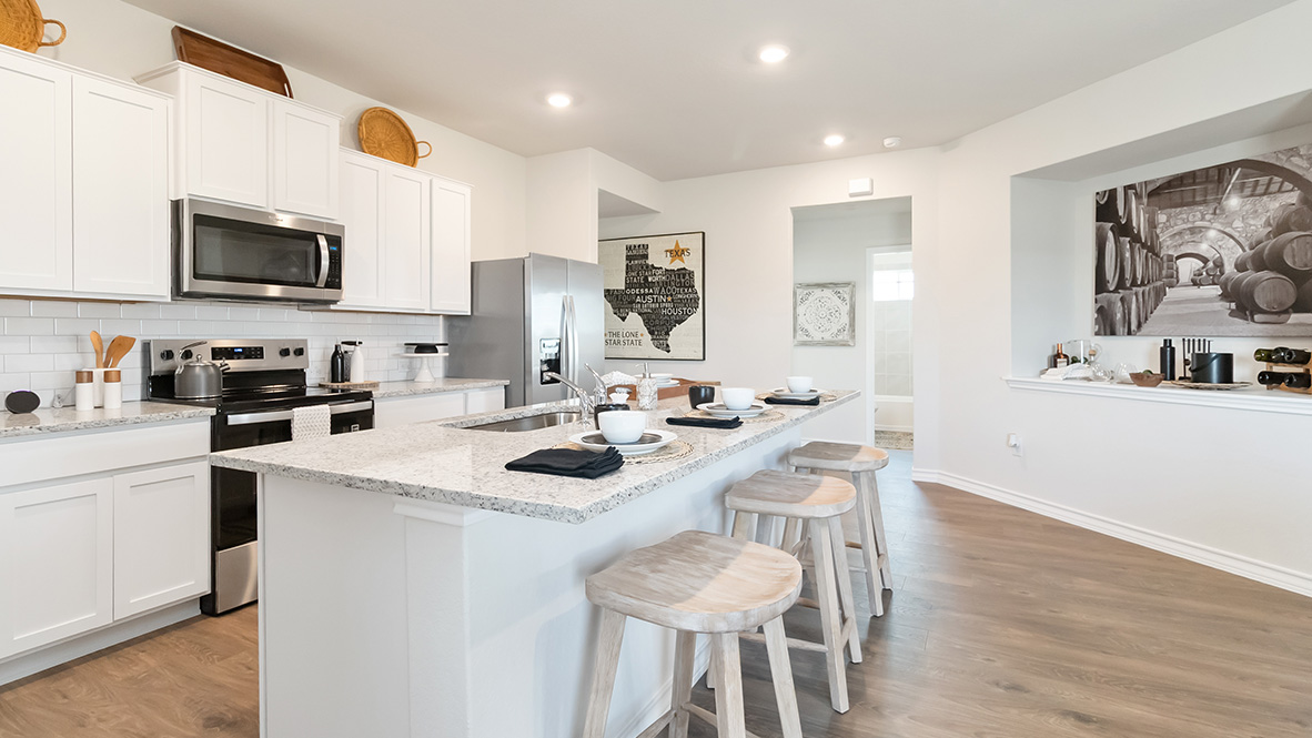 Open-concept kitchen with decorative nook facing the family room.