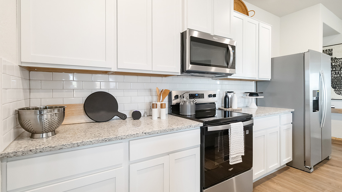 kitchen with stainless steel appliances, abundant cabinets and kitchen island with deep single basin sink