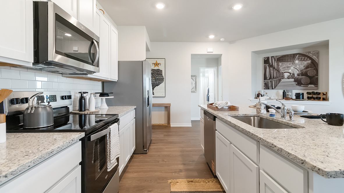 kitchen with stainless steel appliances, abundant cabinets and kitchen island with deep single basin sink