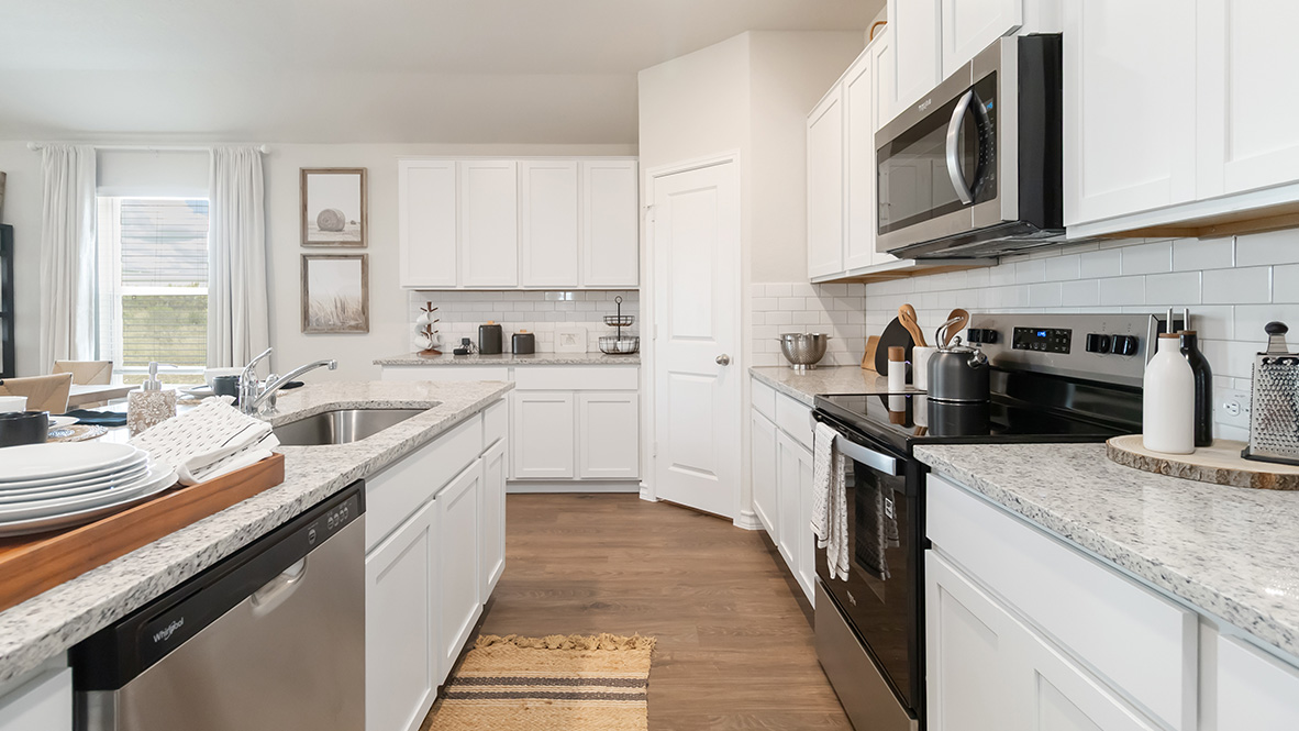 Open-concept kitchen with decorative nook facing the family room.