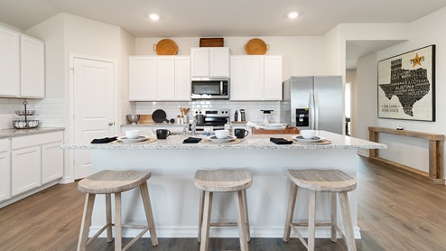 Open-concept kitchen with quartz or quartz countertops, subway tile backsplash, stainless steel appliances and corner pantry