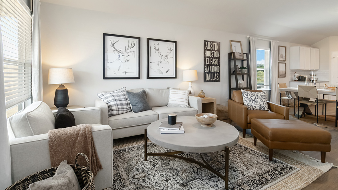 Open-concept family room with hard surface flooring, large windows, and door leading to back patio