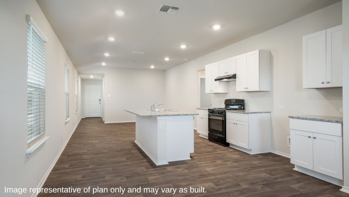 Open-concept dining area overlooking spacious kitchen with hard surface flooring.