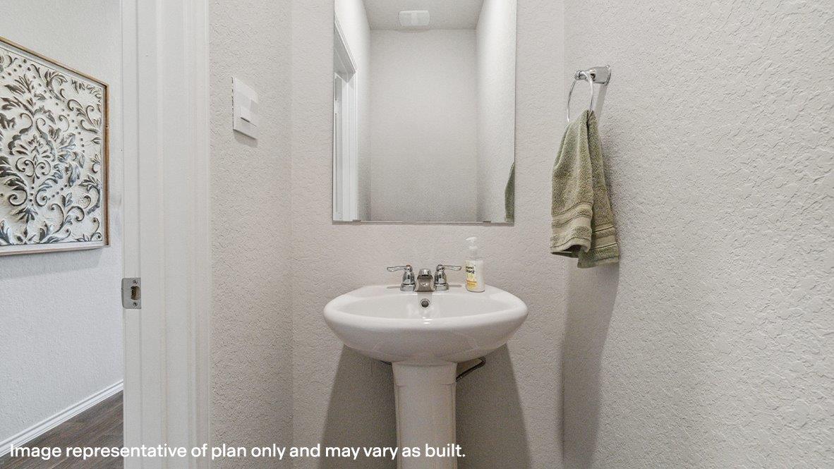 Half bathroom with pedestal sink.