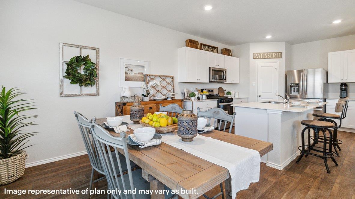 Dining area flowing into kitchen with quality shaker style cabinets.