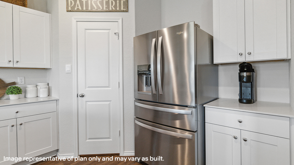 Spacious kitchen island overlooking living room and flowing into dining area with hard surface flooring throughout.