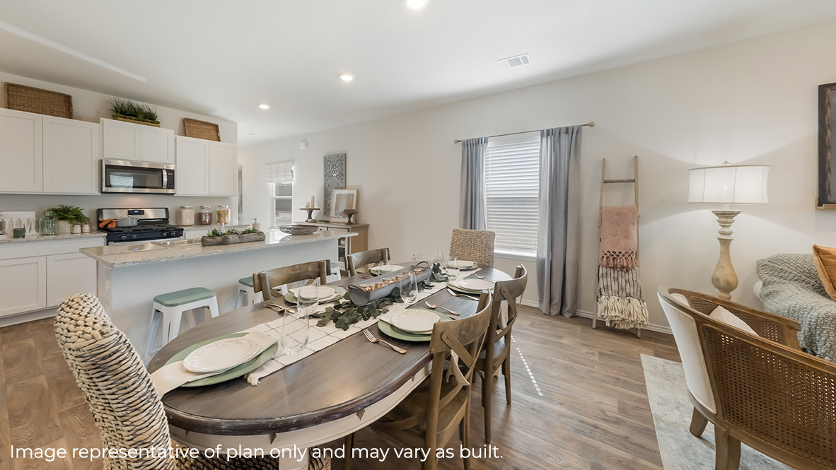 Spacious dining area facing window, sitting between living area and kitchen.