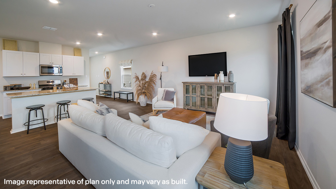 Open-concept living area with hard surface flooring and windows providing plenty of natural light.