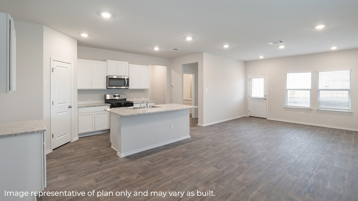 Spacious, open-concept kitchen with island, shaker style cabinets and quartz or quartz countertops.