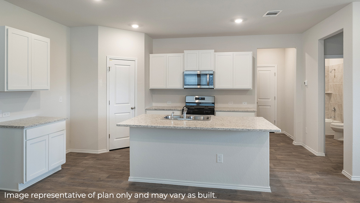 Open-concept kitchen with plenty of counterspace and spacious corner pantry.