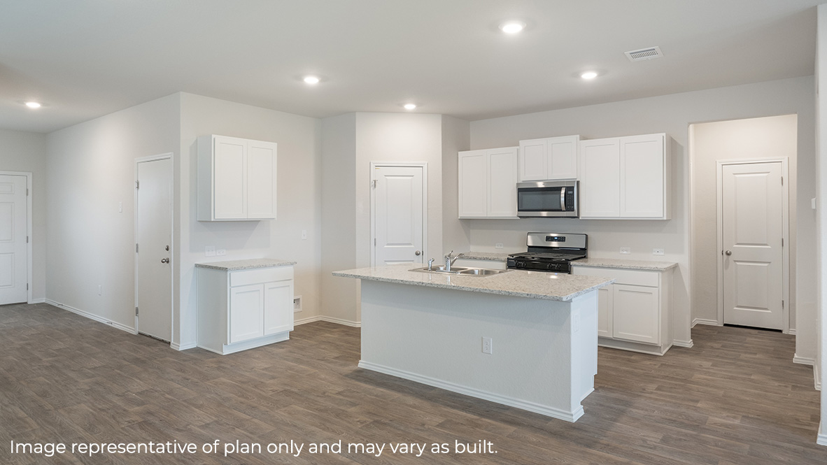 Spacious kitchen with stainless steel appliances and grand island.