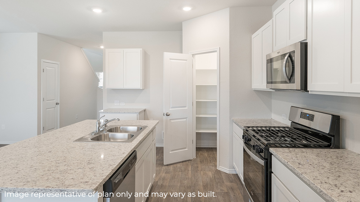 Open-concept kitchen with spacious corner pantry and plenty of cabinet space.