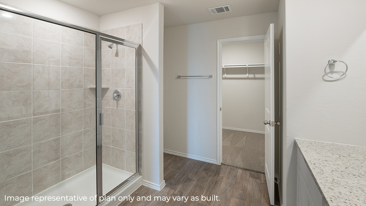 Spacious primary bathroom with plenty of counterspace, single vanity sink and hard surface flooring.