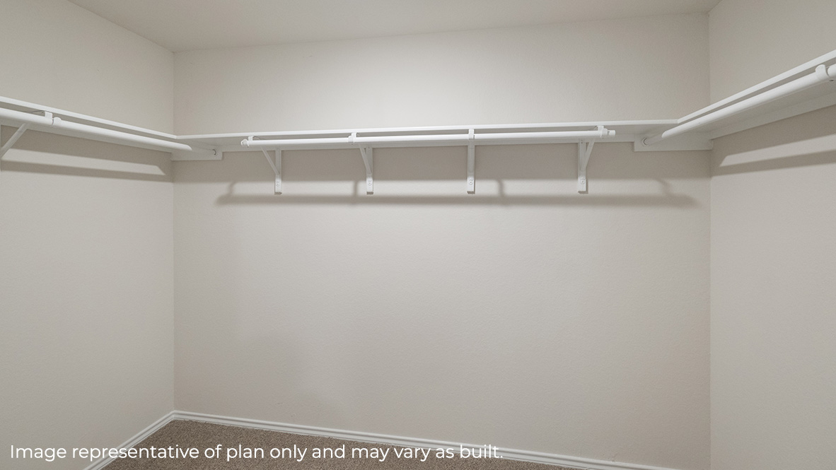 Primary bedroom spacious walk-in closet with shelving.