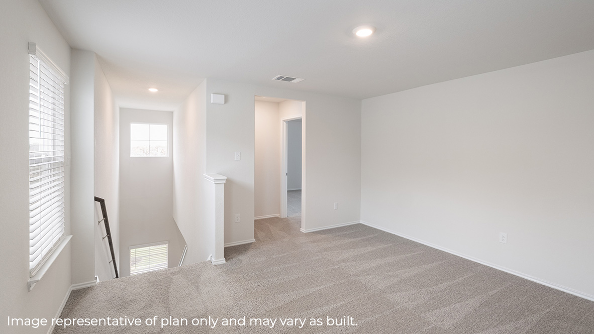 Open-concept loft with carpet and windows.