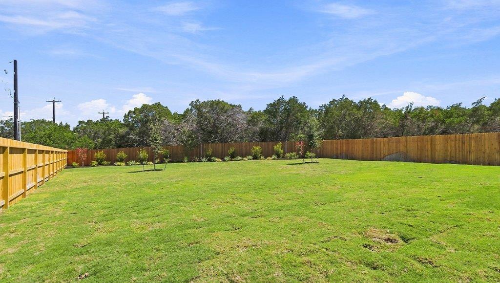 the woodlands at medina hills exterior of model home backyard
