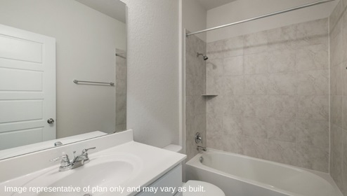 Bulverde Texas DR Horton Homes Copper Canyon Blanco floor plan 1847 square feet one story New Construction Homes Community secondary or guest bathroom with single vanity sink white cabinets mounted wall mirror with bright overhead lighting toilet combined shower and bathtub with tile surround