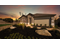Bulverde Texas DR Horton Homes Copper Canyon Model Home Irvine floor plan 1796 square feet single story New Construction Homes dusk evening or twilight view of front exterior of model home with brick and stone exterior features full yard landscaping gated