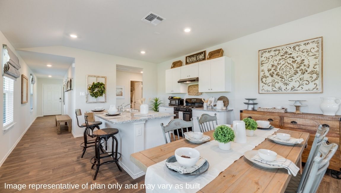 DR Horton San Antonio Laurel Vistas the caroline floor plan 1489 square feet open concept dining area with large farm table and buffet and kitchen with kitchen island and white shaker style cabinetry