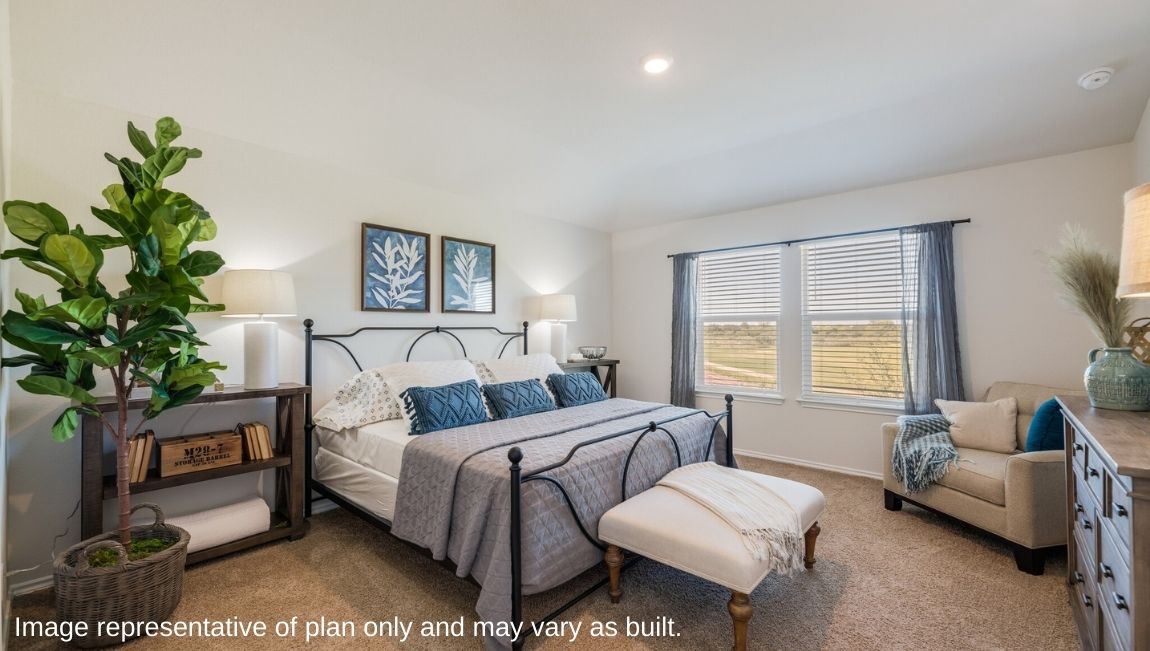 DR Horton San Antonio Laurel Vistas the caroline floor plan 1489 square feet main bedroom suite with carpet flooring, king sized bed, armchair, large houseplant and side tables