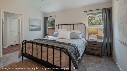 DR Horton San Antonio Laurel Vistas the diana floor plan 1535 square feet main bedroom suite with carpet flooring, king sized bed, side tables set, large windows and a doorway leading to ensuite bathroom
