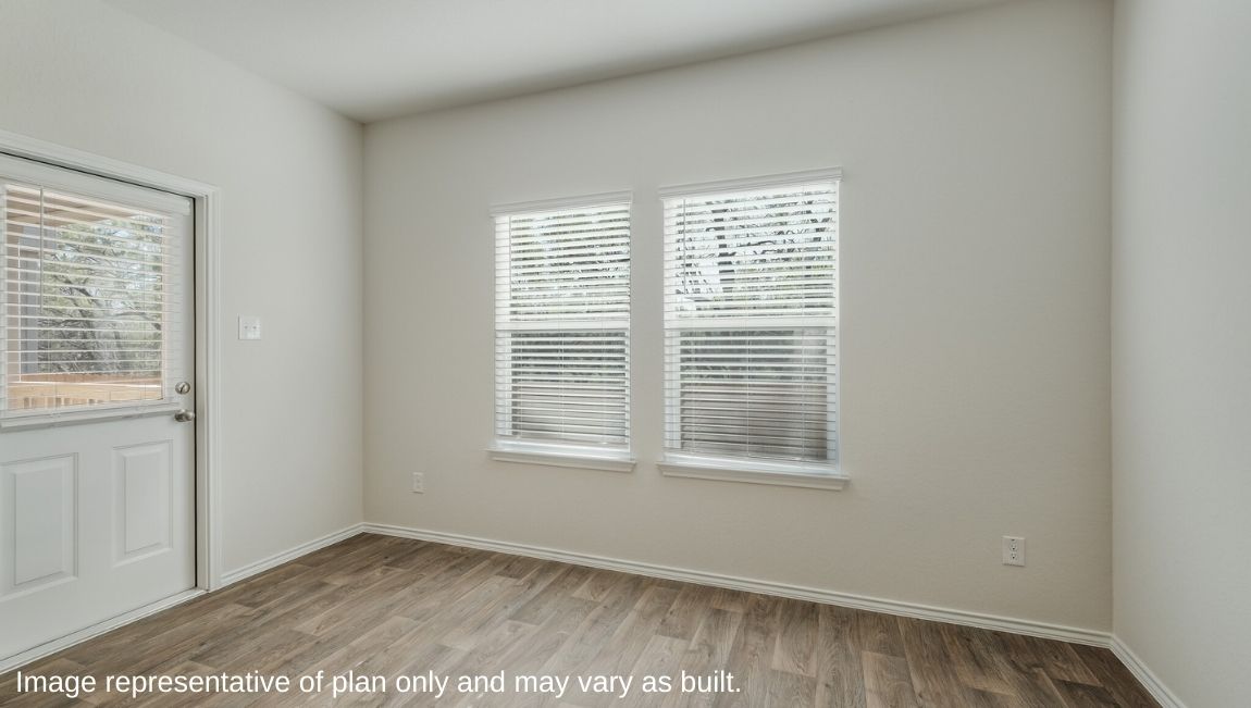 DR Horton San Antonio Laurel Vistas the emma floor plan 1700 square feet dining area with hard surface flooring and large window with doorway leading to back patio and yard