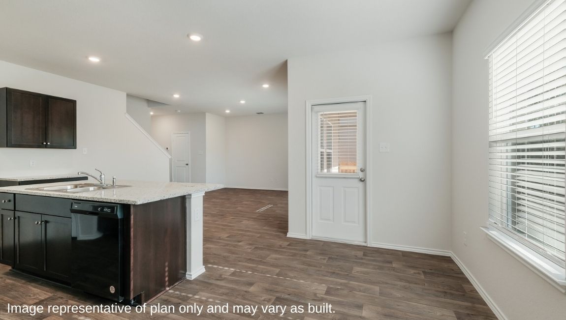 DR Horton San Antonio Laurel Vistas the emma floor plan 1700 square feet dining area with hard surface flooring and large window with doorway leading to back patio and yard