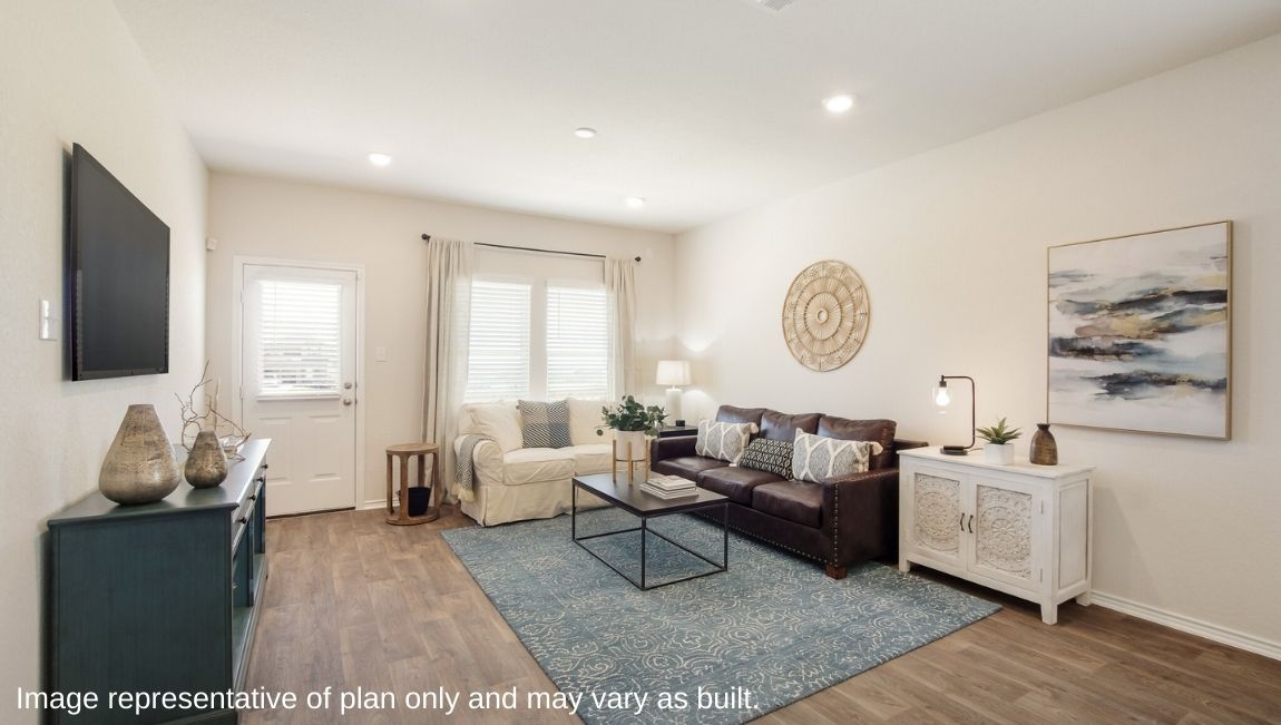 DR Horton San Antonio Laurel Vistas the jasmine floor plan 2182 square feet living room with hard surface flooring, large windows, doorway to back patio, brown leather couch, armchairs, and area rug