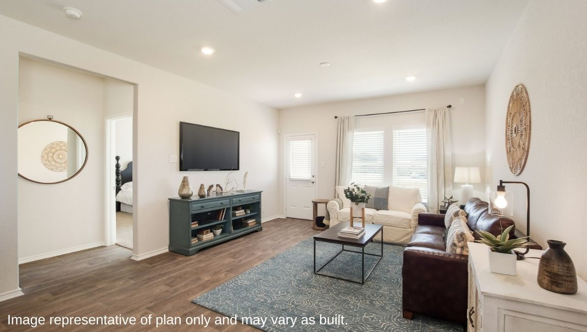 DR Horton San Antonio Laurel Vistas the jasmine floor plan 2182 square feet living room with hard surface flooring, large windows, doorway to back patio, brown leather couch, armchairs, and area rug