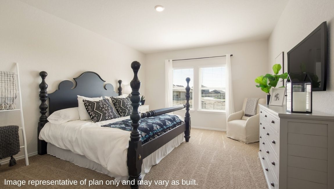 DR Horton San Antonio Laurel Vistas the jasmine floor plan 2182 square feet main bedroom suite with carpet flooring, dresser, armchair, and four poster king sized bed