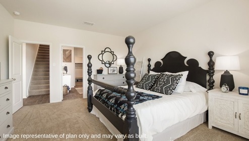 DR Horton San Antonio Laurel Vistas the jasmine floor plan 2182 square feet main bedroom suite with carpet flooring, side table, blanket ladder, and king sized four poster bed with doorway leading to main bedroom suite