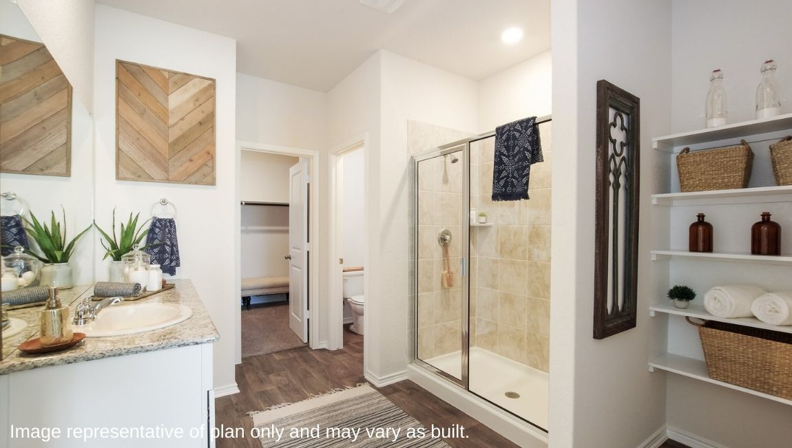 DR Horton San Antonio Laurel Vistas the jasmine floor plan 2182 square feet main bedroom ensuite bathroom with built in shelving unit, single vanity sink, tiled walk in shower, separate door for toilet and carpeted walk in closet