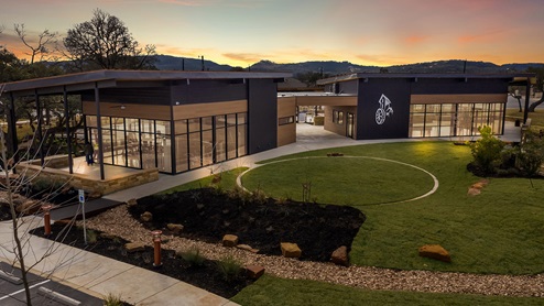 DR Horton Bulverde The Reserve at Copper Canyon resort style amenities dusk aerial view of community center and open lawn