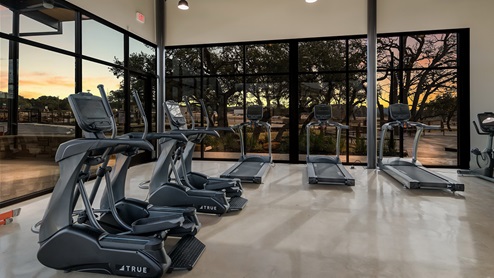 DR Horton Bulverde The Reserve at Copper Canyon resort style amenities fitness center at dusk