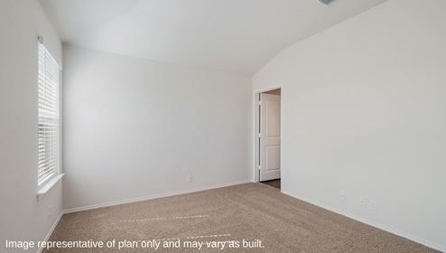 Spacious primary bedroom with ensuite bathroom and walk-in closet.