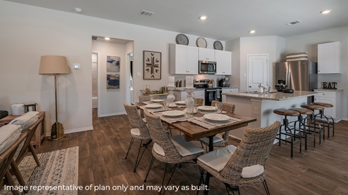 DR Horton San Antonio Riverstone at Westpointe 4922 taconite pass the diana floor plan 1 story 2 car garage 1535 square feet open concept dining area with farm table leading to kitchen with white cabinetry spacious kitchen island and barstools
