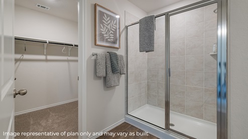 spacious primary bathroom with walk in shower