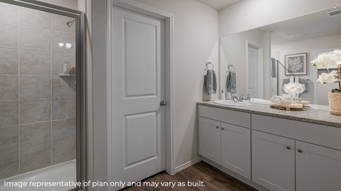 primary bathroom with walk in shower and sink