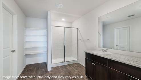 primary bathroom with walk in shower and closet