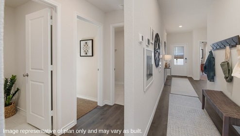 entry hall leading to open concept living room, kitchen and dining area