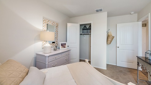 Floresville Links at River Bend New Construction Homes guest bedroom with large walk in closet and full bed
