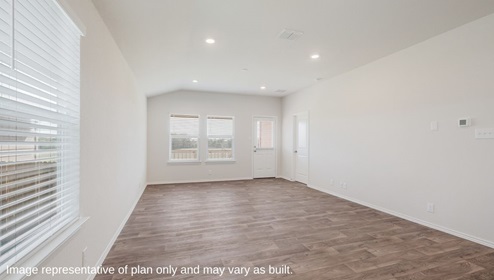 Floresville Links at River Bend New Construction Homes airy open living room with natural light overlooking back patio