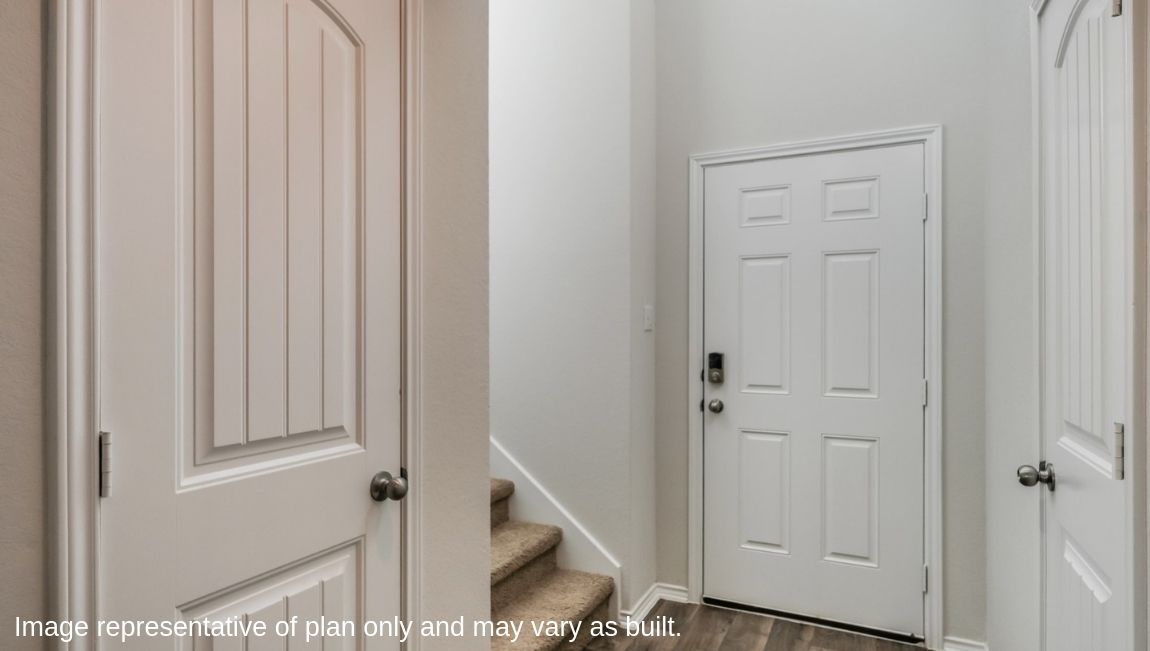Entry leading to foyer, which opens to spacious living area.