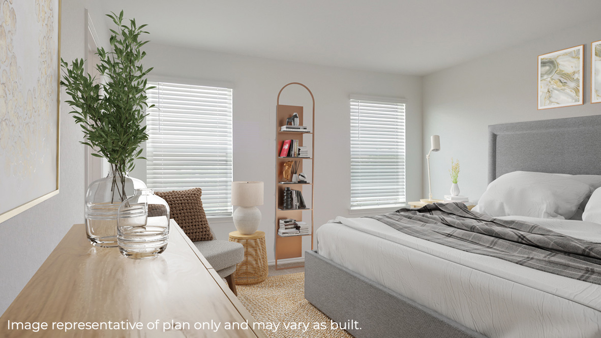 Spacious primary bedroom with ensuite bathroom and windows providing plenty of light.