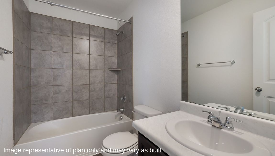Second full bathroom with combined bathtub and shower, toilet and hard surface flooring.