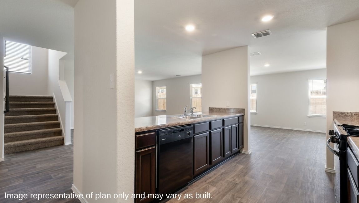 Spacious kitchen with hard surface flooring, plenty of counterspace and cabinet storage.